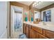 Bright bathroom featuring a double vanity, brown cabinets, and a separate toilet and shower space at 7010 S San Jacinto Ct, Gilbert, AZ 85298