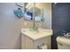 Cozy bathroom featuring neutral gray accents, decorative wall art, and a clean sink at 7010 S San Jacinto Ct, Gilbert, AZ 85298