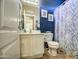 Cozy bathroom featuring blue accents, decorative wall art, and a combined toilet and shower space at 7010 S San Jacinto Ct, Gilbert, AZ 85298