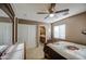 Comfortable bedroom featuring a ceiling fan, carpet, and an en-suite bathroom at 7010 S San Jacinto Ct, Gilbert, AZ 85298