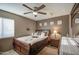 Comfortable bedroom featuring a ceiling fan, carpet, and a wooden sleigh bed frame at 7010 S San Jacinto Ct, Gilbert, AZ 85298