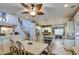 Dining area with a leafy ceiling fan, neutral tones, open floorplan, and a view to the kitchen and staircase at 7010 S San Jacinto Ct, Gilbert, AZ 85298