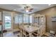 Dining room with a leafy ceiling fan, neutral tones, and a large window for natural light at 7010 S San Jacinto Ct, Gilbert, AZ 85298