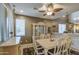 Dining room with decorative ceiling fan, neutral tones, and a view to the kitchen and staircase at 7010 S San Jacinto Ct, Gilbert, AZ 85298