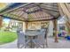 Backyard gazebo with table, seating and curtains, perfect for outdoor dining and entertaining at 7010 S San Jacinto Ct, Gilbert, AZ 85298