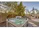 Relaxing backyard hot tub with water feature surrounded by mature landscaping for privacy at 7010 S San Jacinto Ct, Gilbert, AZ 85298