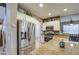 Close-up of kitchen featuring stainless steel refrigerator, granite counters, white cabinets, and stainless appliances at 7010 S San Jacinto Ct, Gilbert, AZ 85298