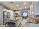 Spacious kitchen featuring granite countertops, stainless steel appliances, and a center island with stool seating at 7010 S San Jacinto Ct, Gilbert, AZ 85298