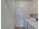 Well-lit laundry room with white cabinets and appliances, providing a functional space at 7010 S San Jacinto Ct, Gilbert, AZ 85298