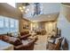 Comfortable living room with two-story ceiling, tile flooring, plush seating, and a large window for natural light at 7010 S San Jacinto Ct, Gilbert, AZ 85298