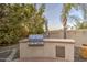 Built-in outdoor grill and counter space for cooking and entertaining in your backyard at 7010 S San Jacinto Ct, Gilbert, AZ 85298