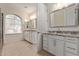 Spacious bathroom with dual vanities featuring granite countertops and a large window for natural light at 7130 W Linda Ln, Chandler, AZ 85226