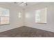 Well-lit bedroom with hardwood floors, two windows, and a ceiling fan at 7130 W Linda Ln, Chandler, AZ 85226