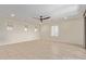 Spacious bedroom featuring neutral decor, tile flooring, and a modern ceiling fan at 7130 W Linda Ln, Chandler, AZ 85226