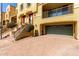 Exterior of a townhome with garage, staircase, and charming architectural details at 7130 W Linda Ln, Chandler, AZ 85226