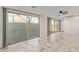 A living room with multiple slider door entrances to a patio area at 7130 W Linda Ln, Chandler, AZ 85226