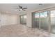 A living room with a ceiling fan, recessed lighting, and multiple slider doors at 7130 W Linda Ln, Chandler, AZ 85226