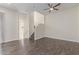 Bright living room boasts wood flooring, a modern ceiling fan, and staircase access to the upper level at 7130 W Linda Ln, Chandler, AZ 85226