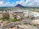 Aerial view of cityscape with multi-story buildings and mountain backdrop at 7151 E Rancho Vista Dr # 1017, Scottsdale, AZ 85251