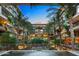 Exterior view of multi-story condo building with lush landscaping in courtyard at 7151 E Rancho Vista Dr # 1017, Scottsdale, AZ 85251