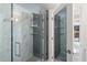 Elegant shower with marble and tile walls, glass door, rainfall shower head, and built-in shelving at 7151 E Rancho Vista Dr # 1017, Scottsdale, AZ 85251