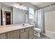 Well-lit bathroom featuring a large mirror and stylish gray wood-look tile floor at 726 E Aire Libre Ave, Phoenix, AZ 85022