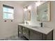 Stylish bathroom featuring double vanity with modern fixtures and a separate shower at 726 E Aire Libre Ave, Phoenix, AZ 85022