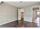 Neutral bedroom with wood-look flooring, open closet, and light grey walls at 726 E Aire Libre Ave, Phoenix, AZ 85022