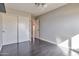 Cozy bedroom featuring light grey walls, ceiling fan, and closet with sliding doors at 726 E Aire Libre Ave, Phoenix, AZ 85022