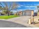 Charming single Gathering home with long driveway, large tree, and freshly cut grass at 726 E Aire Libre Ave, Phoenix, AZ 85022