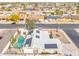 Aerial view of home with solar panels, in-ground pool and pergola at 790 N Meadows Dr, Chandler, AZ 85224