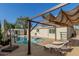 Backyard with a covered pergola, in-ground pool and lounge chairs at 790 N Meadows Dr, Chandler, AZ 85224