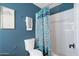 Bathroom features a blue accent wall, decorative shower curtain and white tile in shower at 790 N Meadows Dr, Chandler, AZ 85224