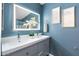 Bathroom vanity features double sinks, decorative flower vase, and a lighted mirror at 790 N Meadows Dr, Chandler, AZ 85224