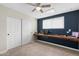 This bedroom features a built in desk, ceiling fan and blue accent wall at 790 N Meadows Dr, Chandler, AZ 85224