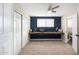 The bedroom has an accent wall, built-in desk, and a ceiling fan at 790 N Meadows Dr, Chandler, AZ 85224