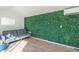 This flex room has a grass wall, hardwood floors, and an AC unit at 790 N Meadows Dr, Chandler, AZ 85224