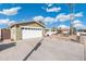 View of front yard, two car garage, driveway and well-maintained rock landscaping at 790 N Meadows Dr, Chandler, AZ 85224