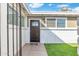 Inviting front entrance with brick accents, a dark wood door, and well-placed windows at 790 N Meadows Dr, Chandler, AZ 85224