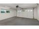 Spacious garage featuring a white brick wall and a large window for natural light at 790 N Meadows Dr, Chandler, AZ 85224