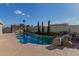 Backyard view of the in-ground pool with rock features at 790 N Meadows Dr, Chandler, AZ 85224