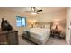 Bright bedroom with a cozy bed, modern ceiling fan and large dresser at 7950 E Keats Ave # 150, Mesa, AZ 85209