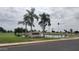 Scenic view of Sunland Village East Golf Club with lush greenery and palm trees under a partly cloudy sky at 7950 E Keats Ave # 150, Mesa, AZ 85209