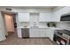 Well-lit kitchen with white cabinets, stainless steel appliances, and quartz countertops at 7950 E Keats Ave # 150, Mesa, AZ 85209