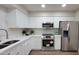 Bright kitchen featuring white cabinetry, stainless steel appliances, and a sleek, modern design at 7950 E Keats Ave # 150, Mesa, AZ 85209