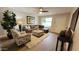 Cozy living room showcasing a gray sectional, soft area rug, and a bright window for natural light at 7950 E Keats Ave # 150, Mesa, AZ 85209