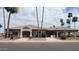 Exterior view of the Gathering restaurant with a tile roof and tall palm trees at 7950 E Keats Ave # 150, Mesa, AZ 85209