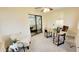 Bright sunroom with neutral carpet and a modern wooden desk offering a tranquil space for work or relaxation at 7950 E Keats Ave # 150, Mesa, AZ 85209