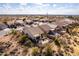 Bird's eye view of backyards in a desert neighborhood, showcasing outdoor living spaces and landscaping at 8142 S Open Trail Ln, Gold Canyon, AZ 85118