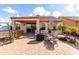 Comfortable backyard featuring a covered patio and luxurious outdoor seating area at 8142 S Open Trail Ln, Gold Canyon, AZ 85118